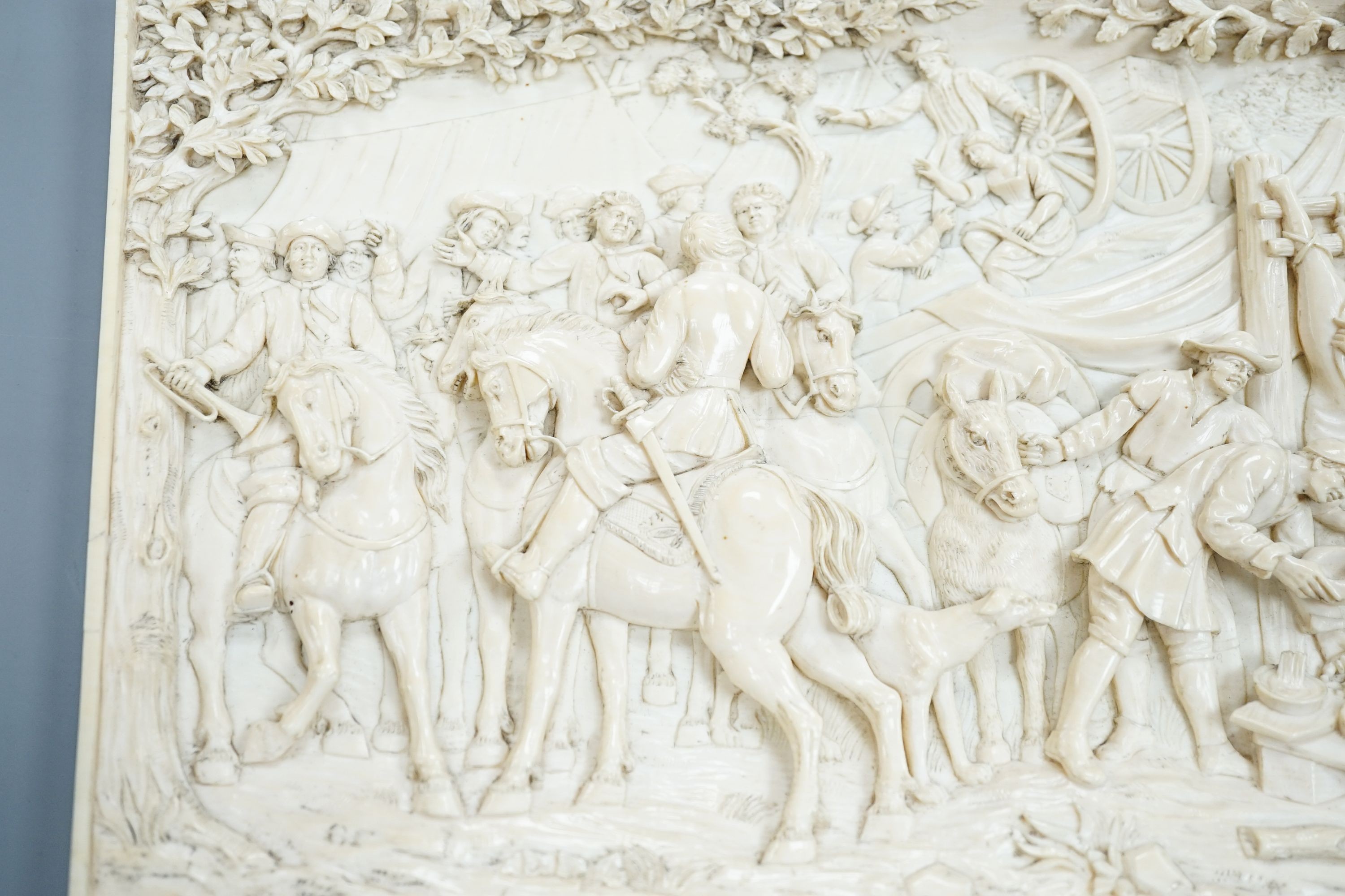 An 18th century Flemish carved ivory plaque (initials OF?) with scenes of hunters and village life, 15 x 28cm
